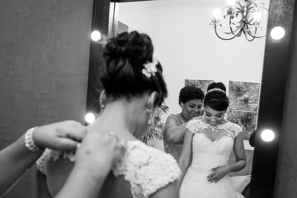 mãe ajustando vestido da filha no making of fotógrafo fabio doria 