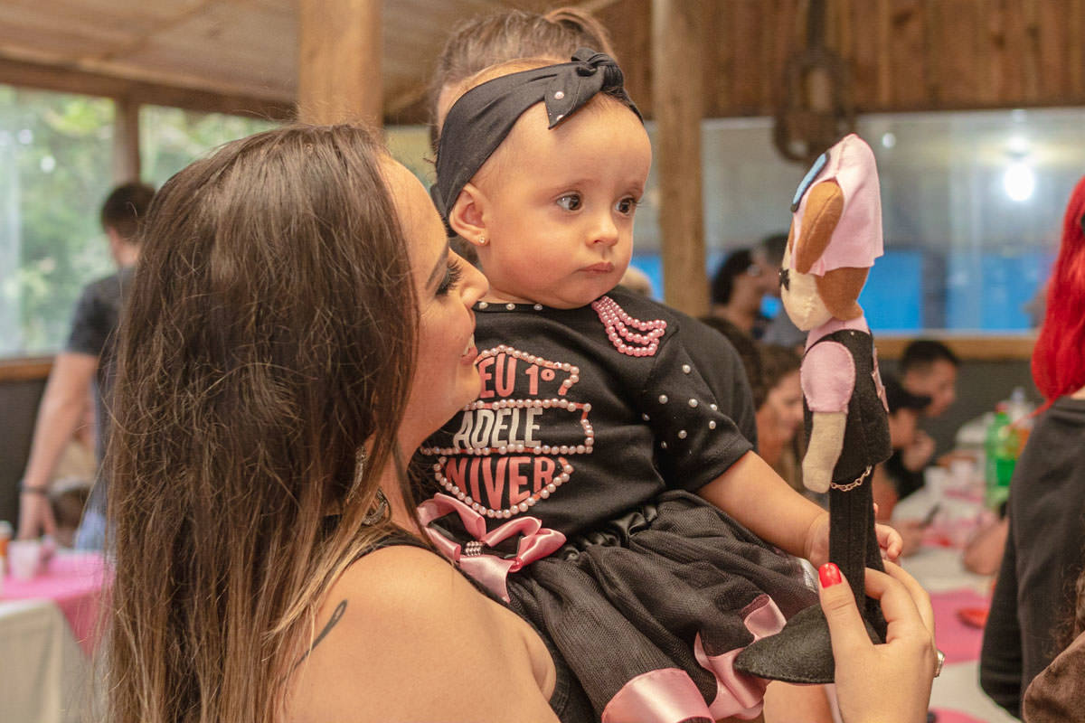 bebê Menina no colo da mãe na festa de 1 ano 