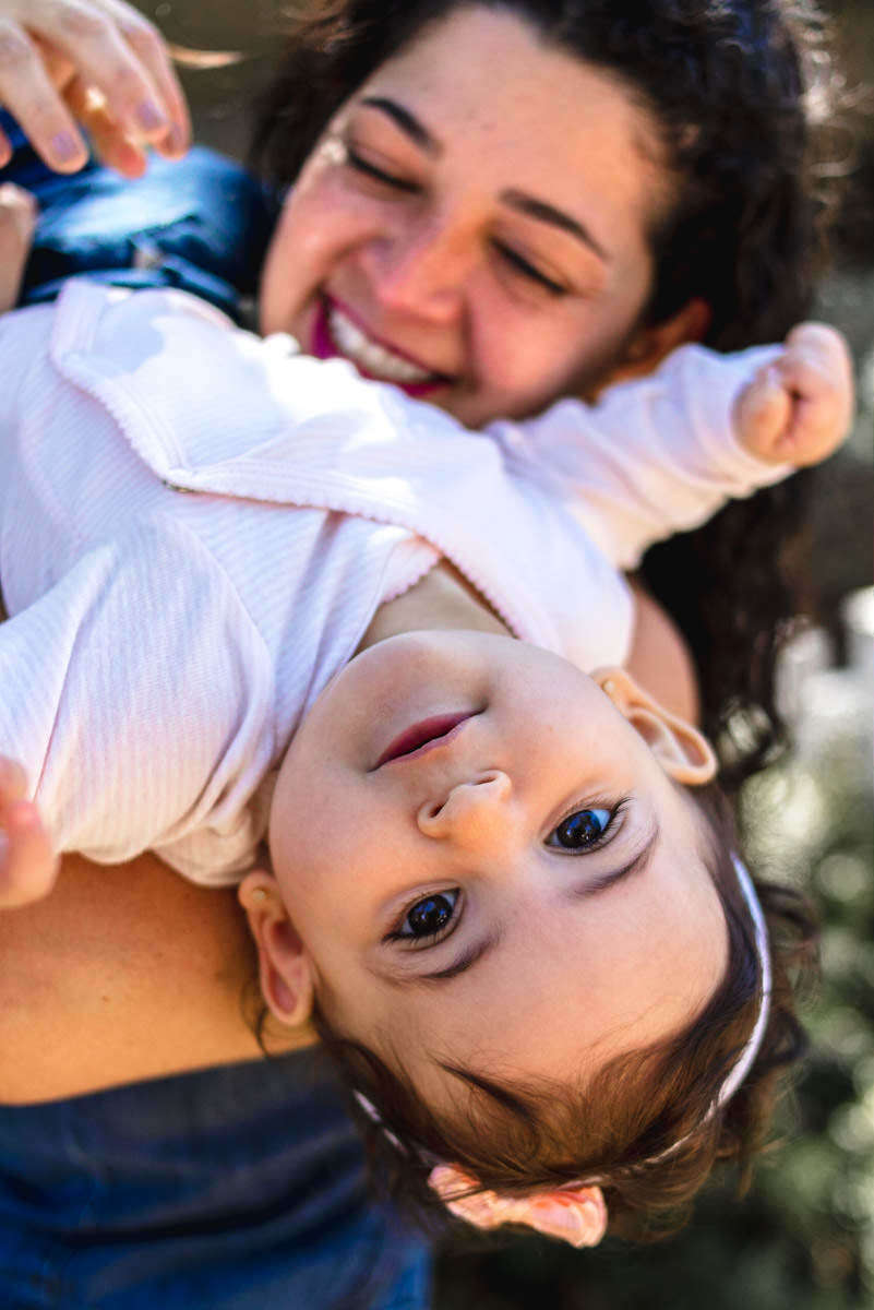 mãe virando a filha de cabeça pra baixo