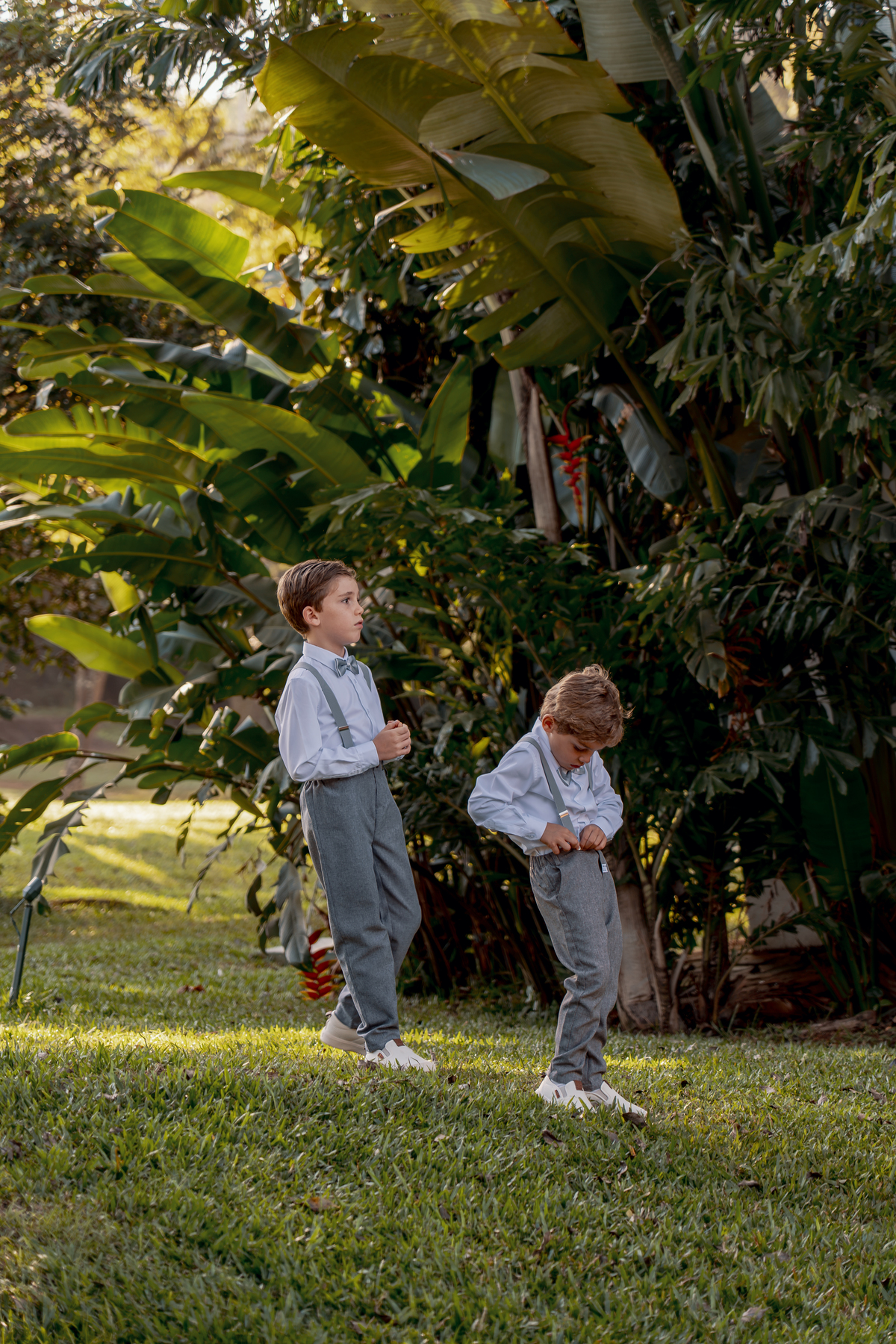 Crianças entre a vegetação durante a celebração do casamento no campo.