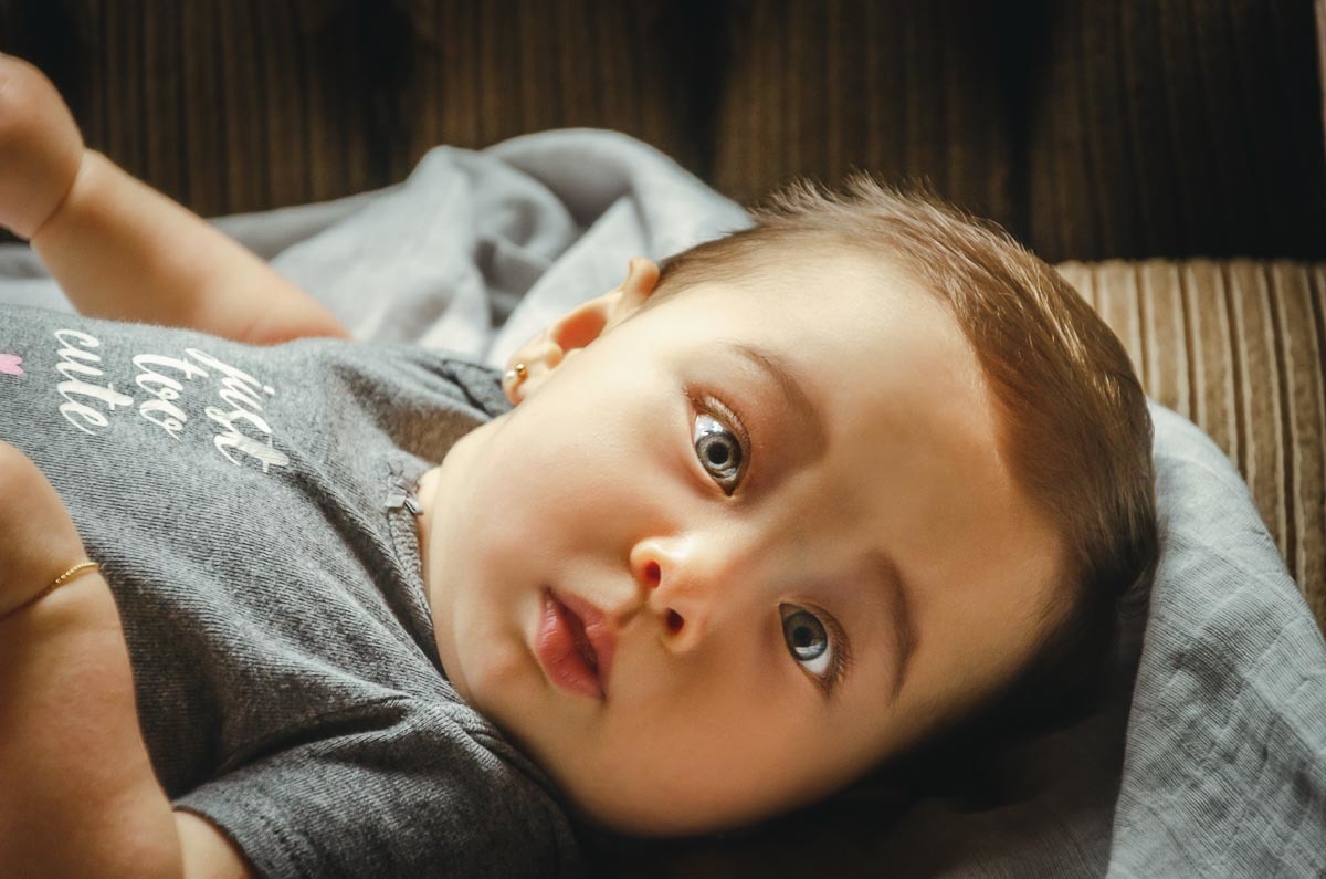 Bebê menina sendo arrumado para batismo