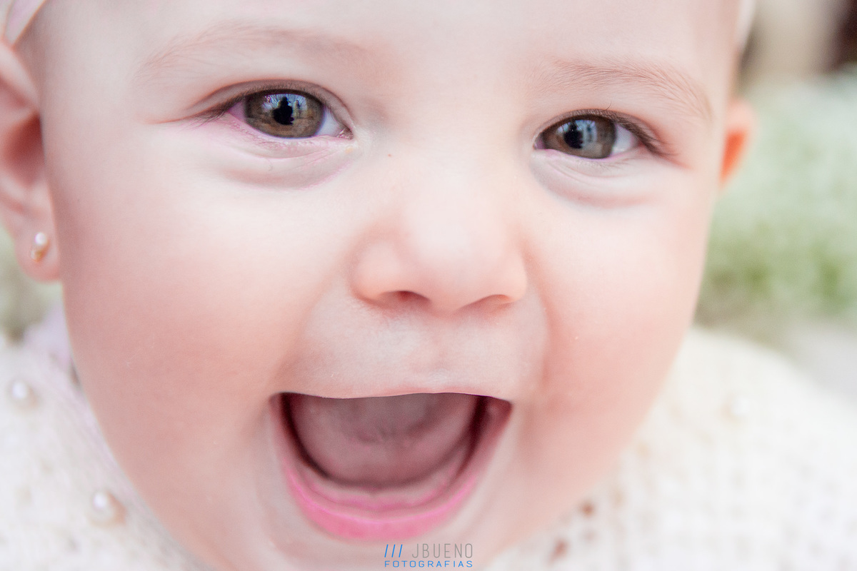 nenê sorrindo no dia de seu batismo