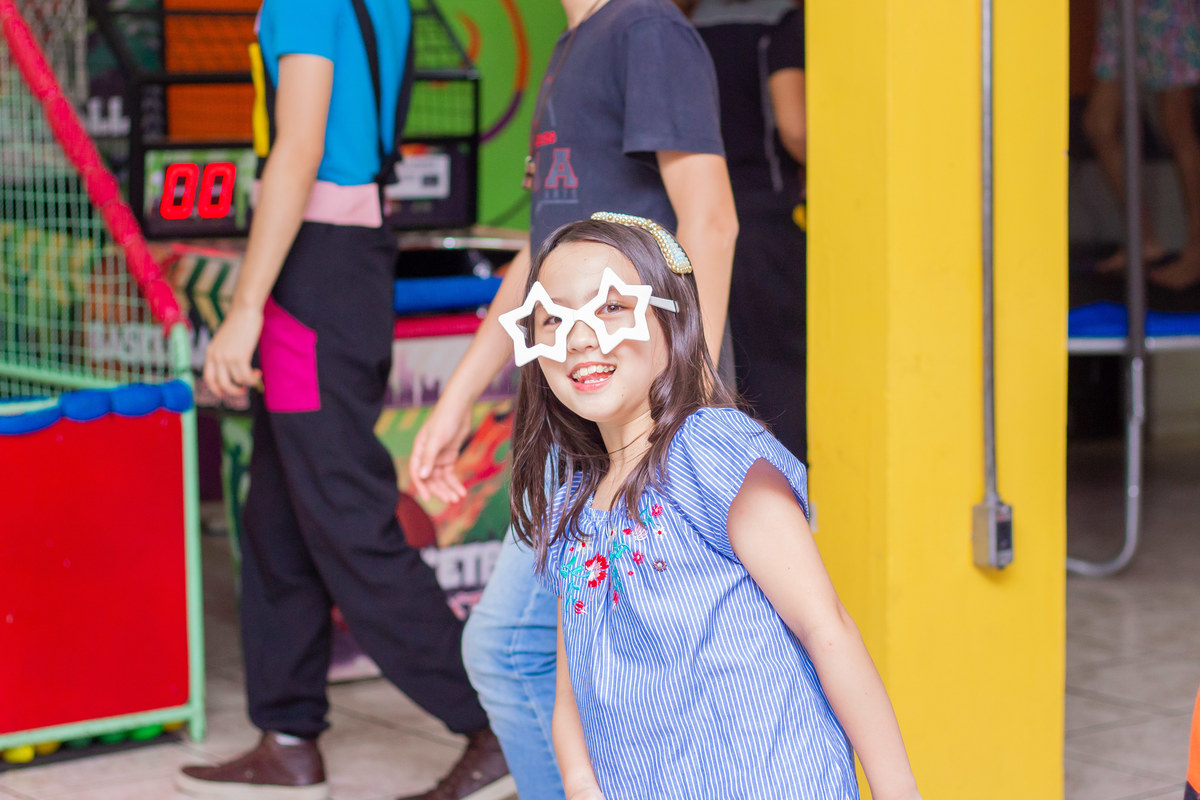 Menina sorrindo com óculos maluco
