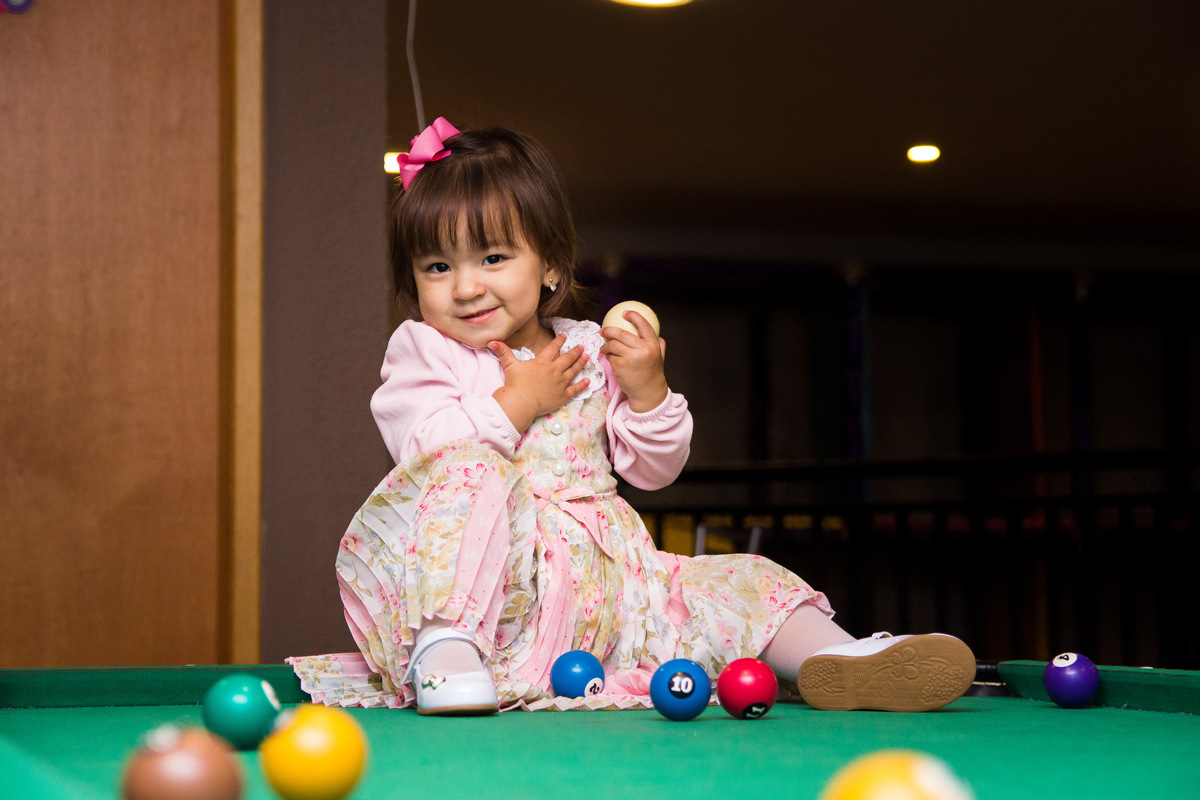 Aniversariante brincando na mesa de sinuca