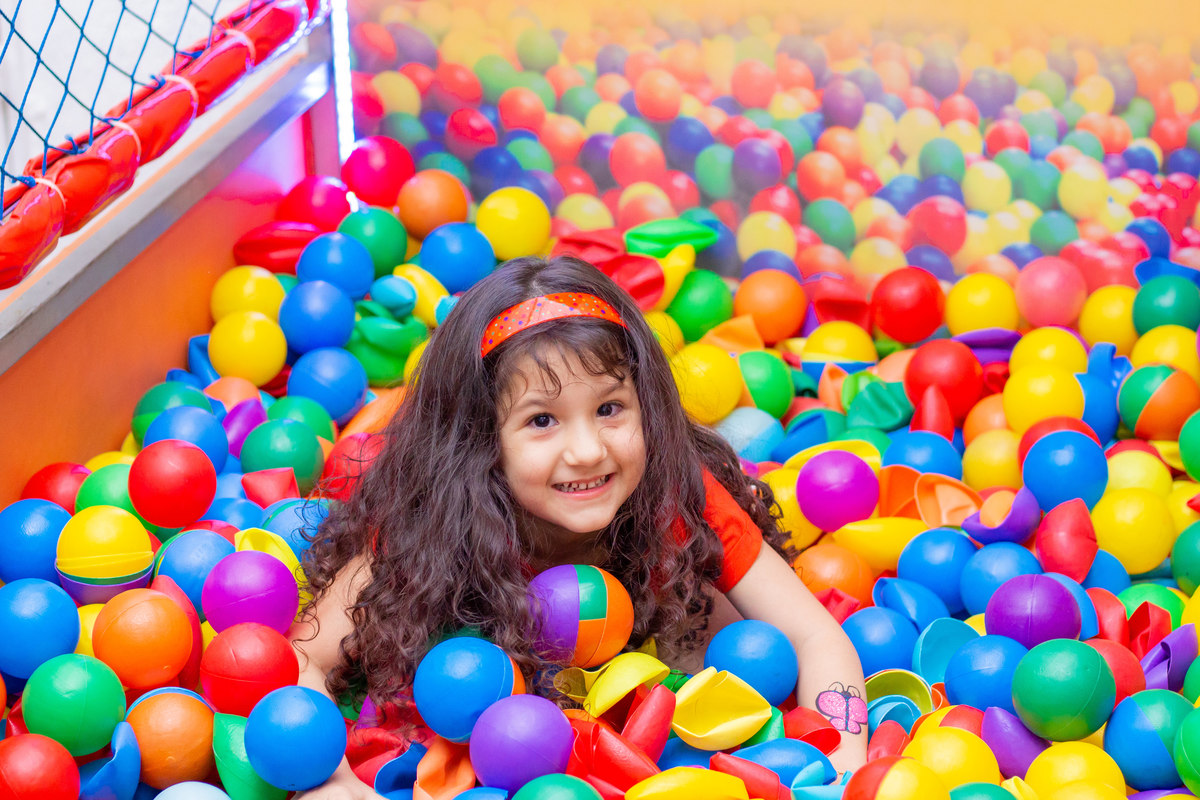 Garota brincando na piscina de bolinhas