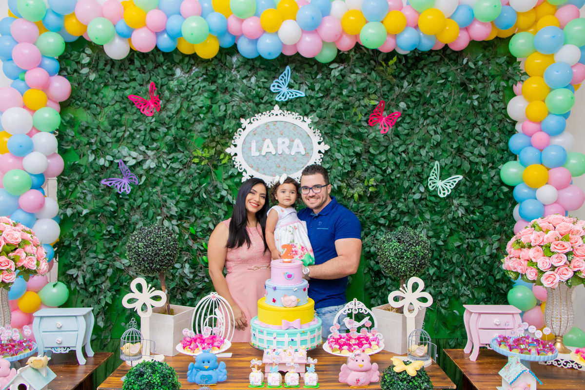 Foto com os pais na mesa do bolo