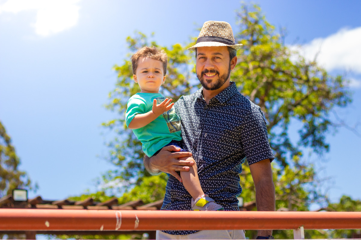 Pai e aniversariante sorrindo no campo