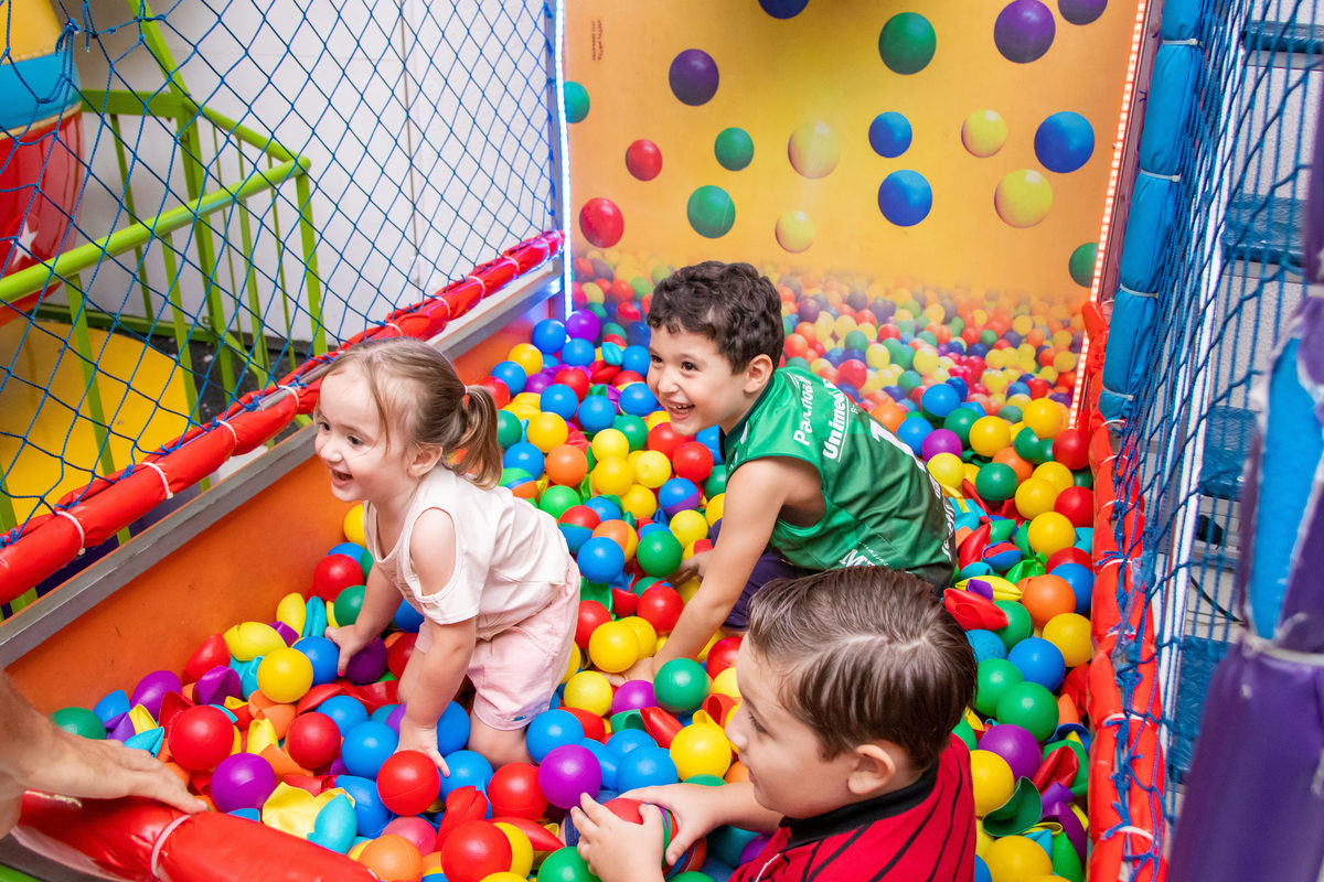 crianças brincando na piscina de bolinha