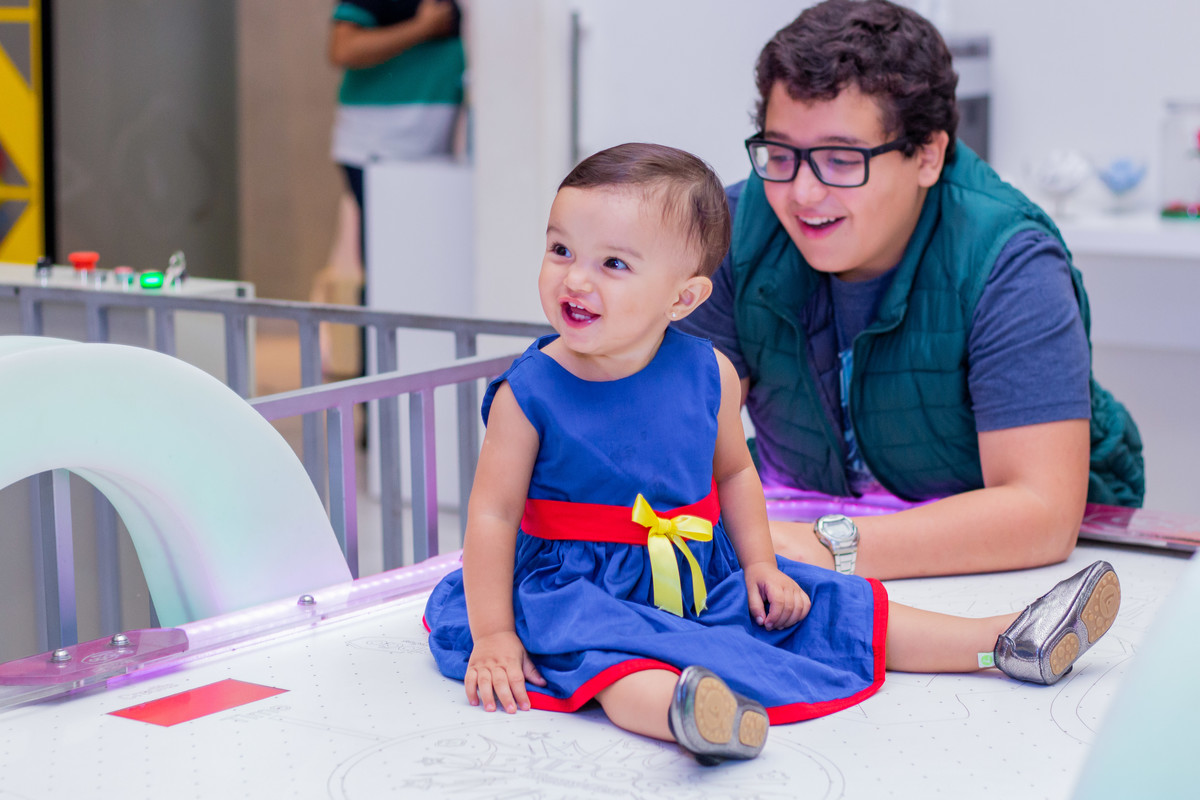 nenê brincando na mesa do air hockey