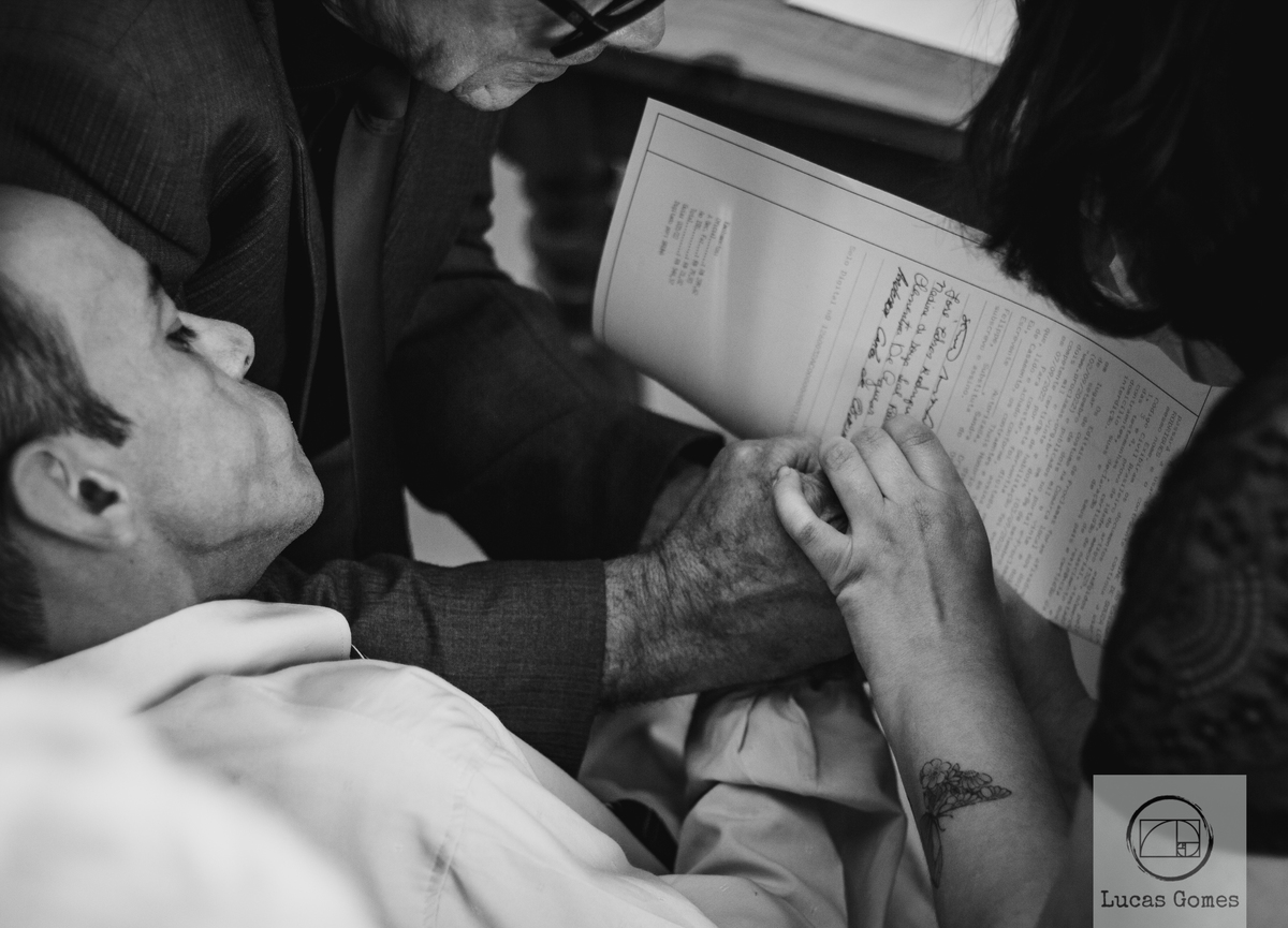 Pai do noivo ajudando a registrar o seu documento no  cartório 