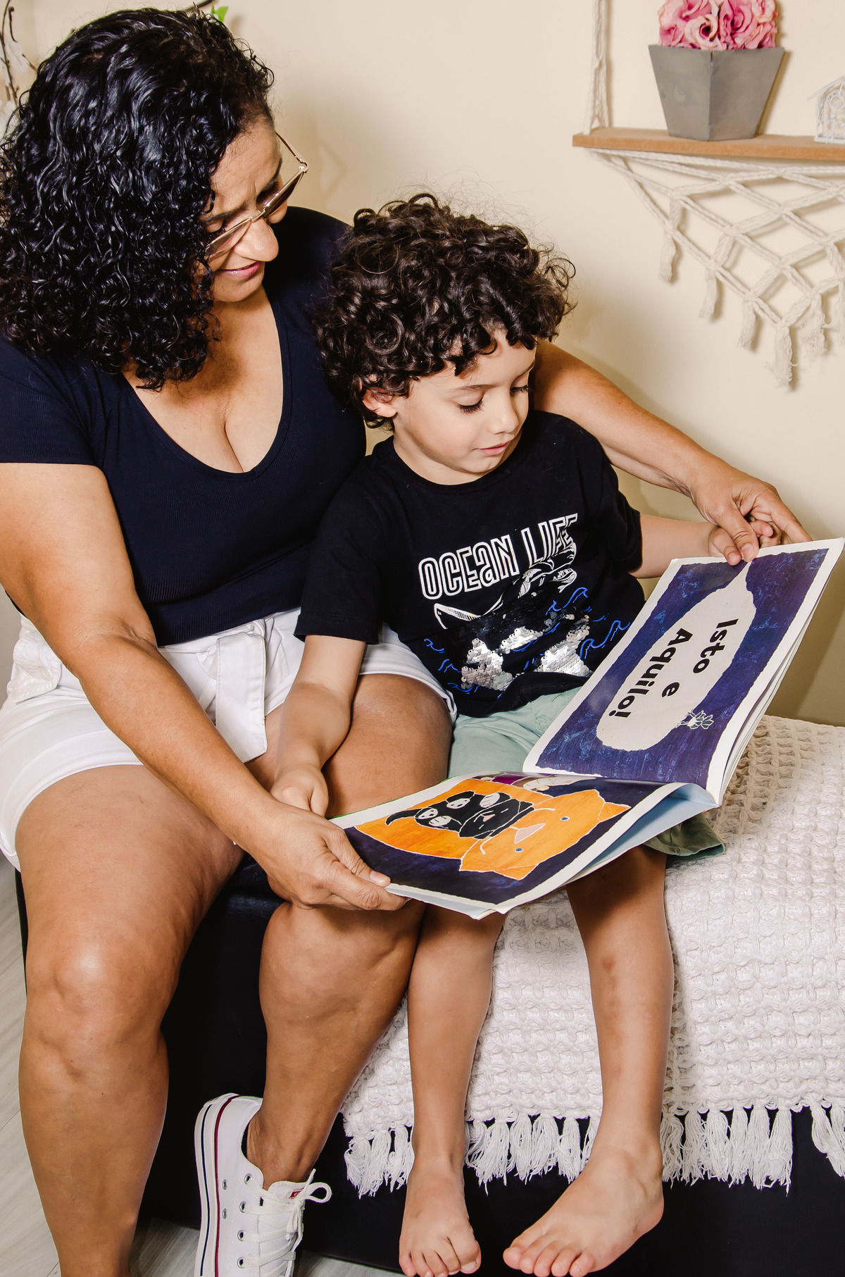 foto avo lendo livro de historias para neto camisa preta