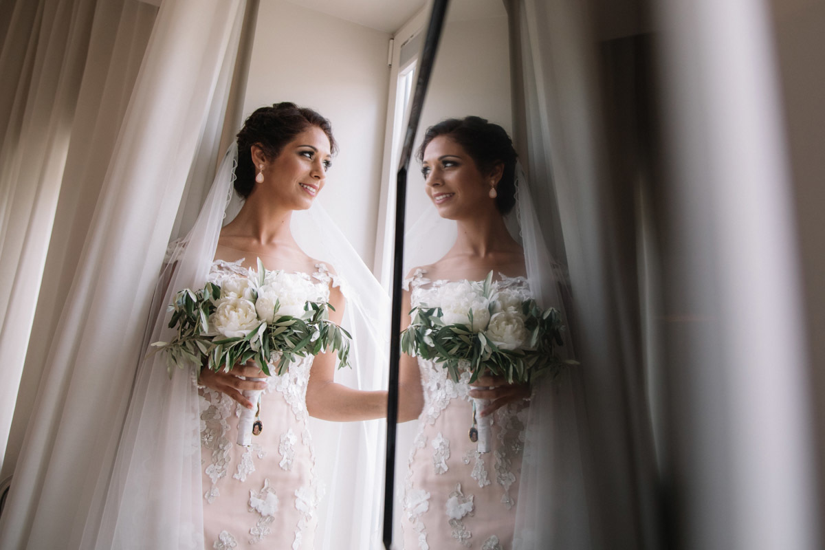 Bride looking at herself in the mirror
