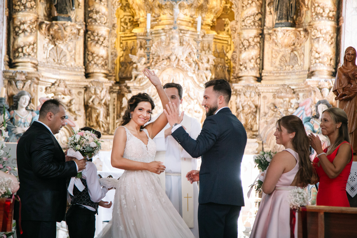 noivos festejam com os convidados depois de colocarem as alianças
