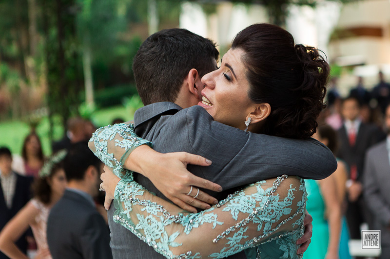 irmã do noivo Pedro o cumprimenta durante a cerimônia de casamento nesta fotografia natural e espontânea de Andre Attene