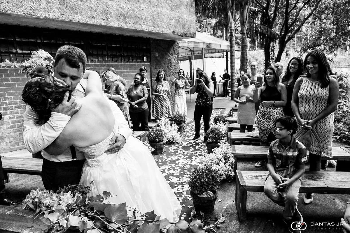 casal de noivos se beijando durante cerimônia de casamento ao ar livre por Dantas Jr.