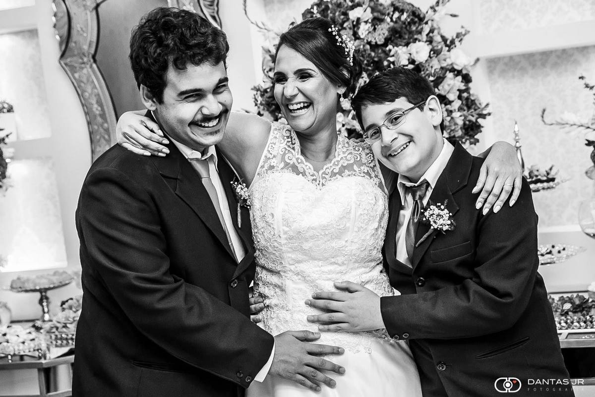 mulher vestida de noiva gravida com filhos fazendo carinho na barriga