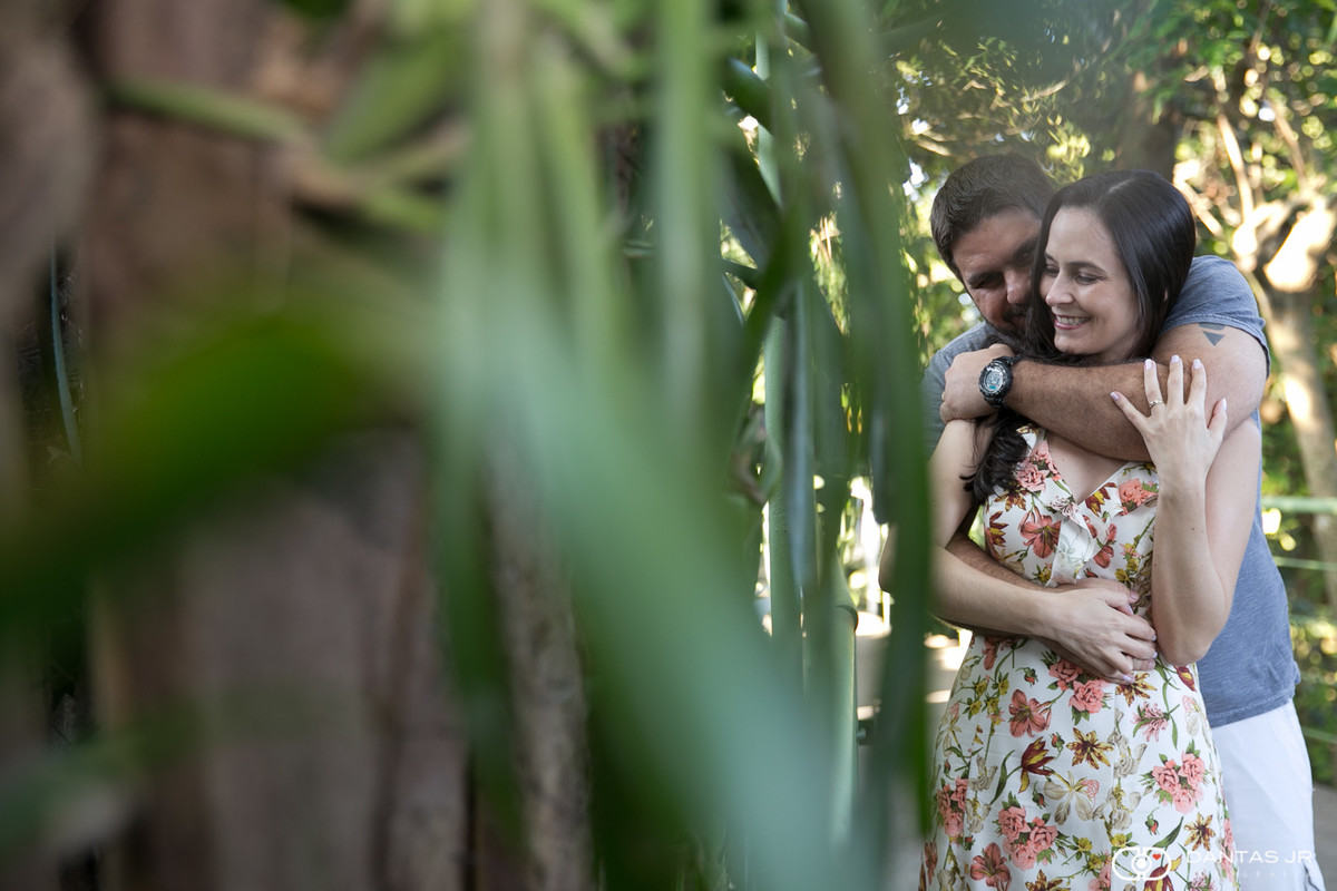 casal sendo espionado através de plantas enquanto namora