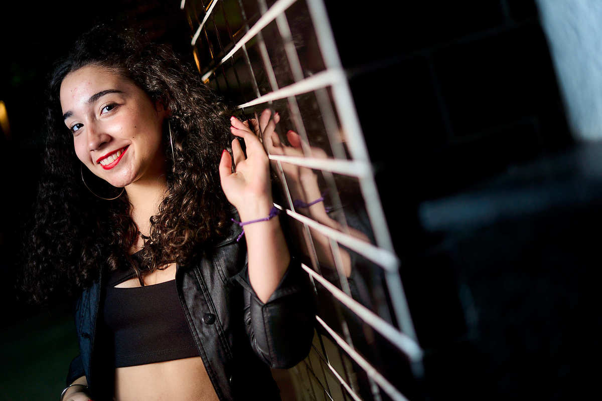 fotografia con reflejos en pared nocturna de quinceañera con labios rojos