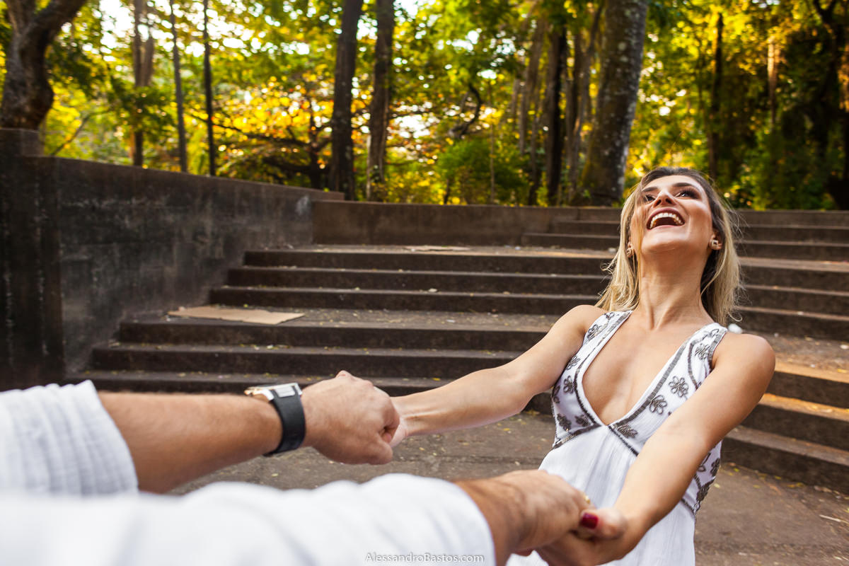 olhando pra cima está a noiva enquanto os noivos no ensaio pre-wedding para a fotografia do casamento em bh giram
