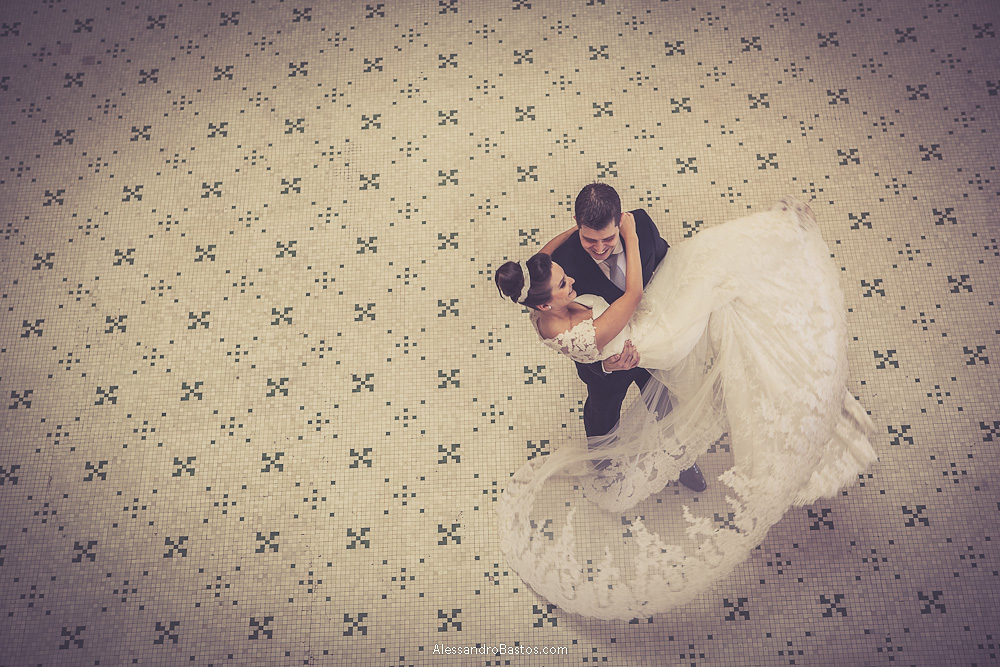 girando a noiva nas fotos do casamento em bh no buffet catharina dos noivos na fotografia em belo horizonte para o fotografo bh no museu de artes e ofícios e a calda do vestido dela se abre sobre o azulejo histórico do chão