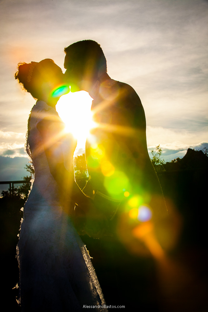 raio de luz entra na lente nas fotografias após o casamento em bh na serra da piedade e causa um efeito de estrela do sol