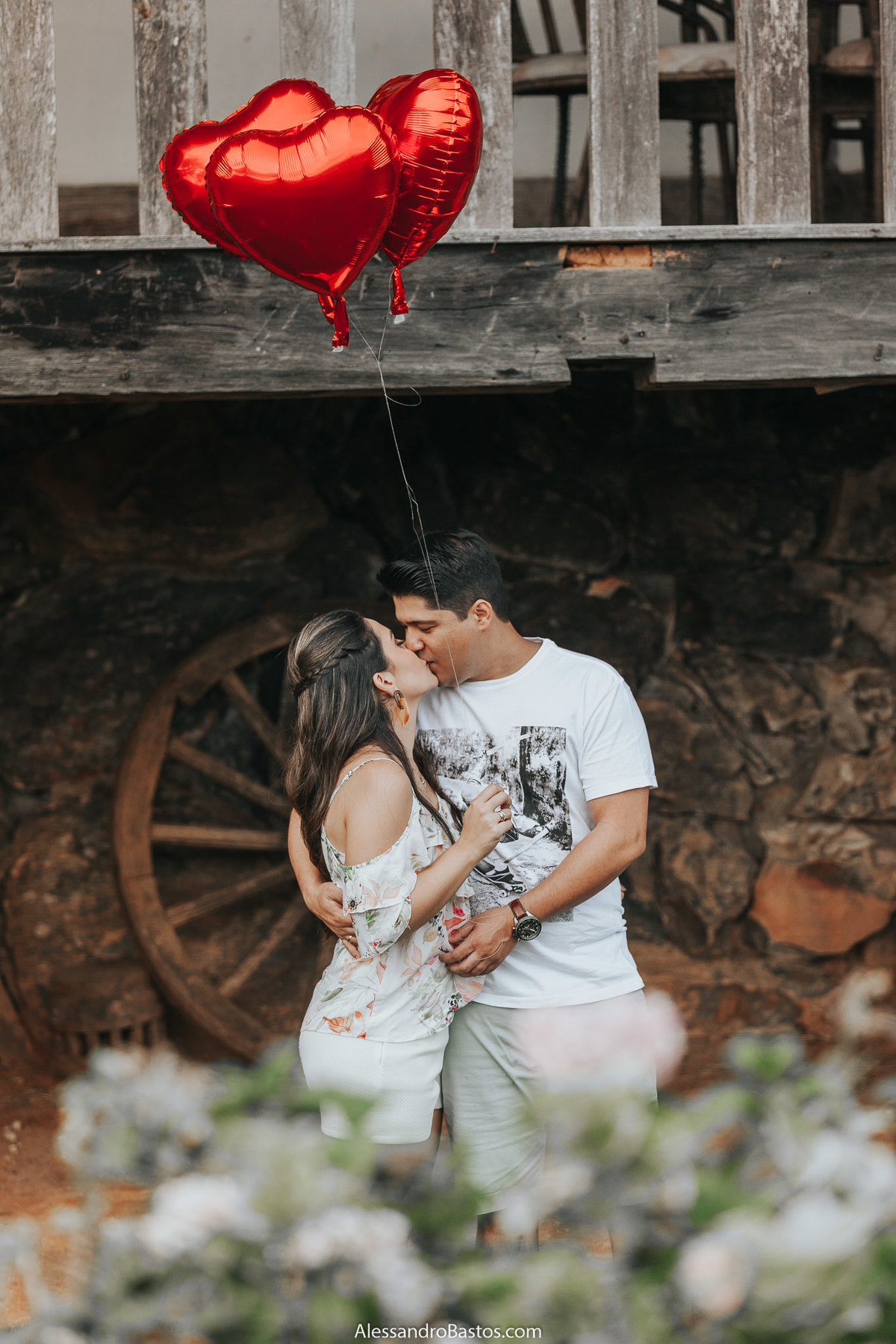 beijando a noiva na sessão de fotos para casamento em bh na fazenda solar do engenho e segurando balão de coração