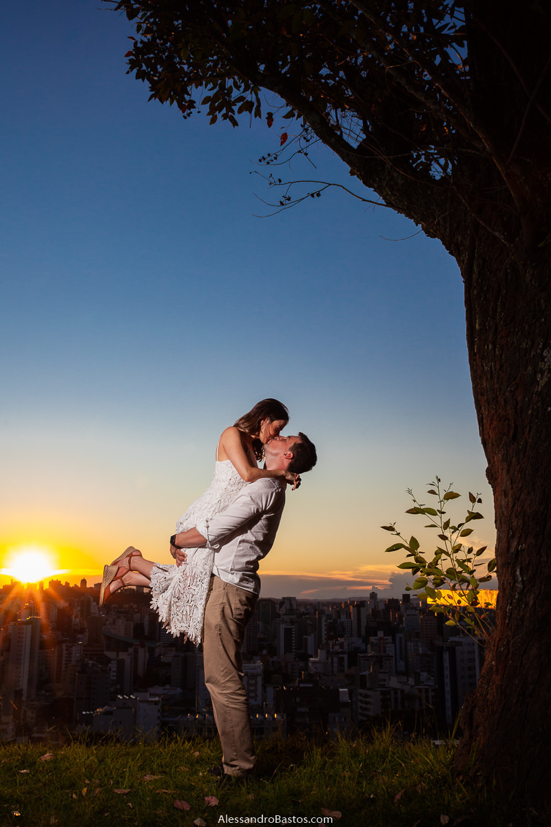 levantou a noiva nas fotos de noivos para casamento em bh fotografo durante o sol se pondo