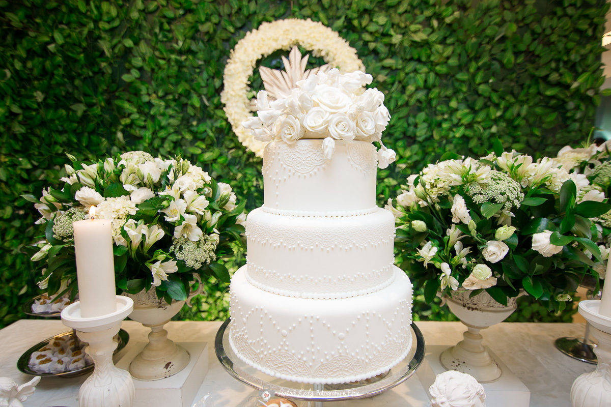 Na decoração do batizado foi usado um bolo de três andares branco muito sofisticado