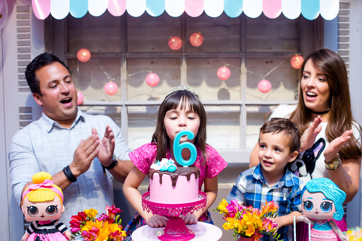 Fotografia da família na mesa da LOL surpise durante o parabéns no buffet miniland tatuapé sp