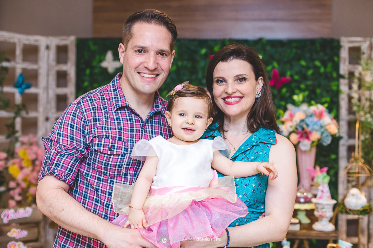 Retrato  da família em frente a  sua mesa decorada com o tema jardim