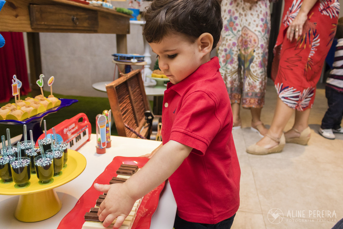 criança brincando com piano de kitkat