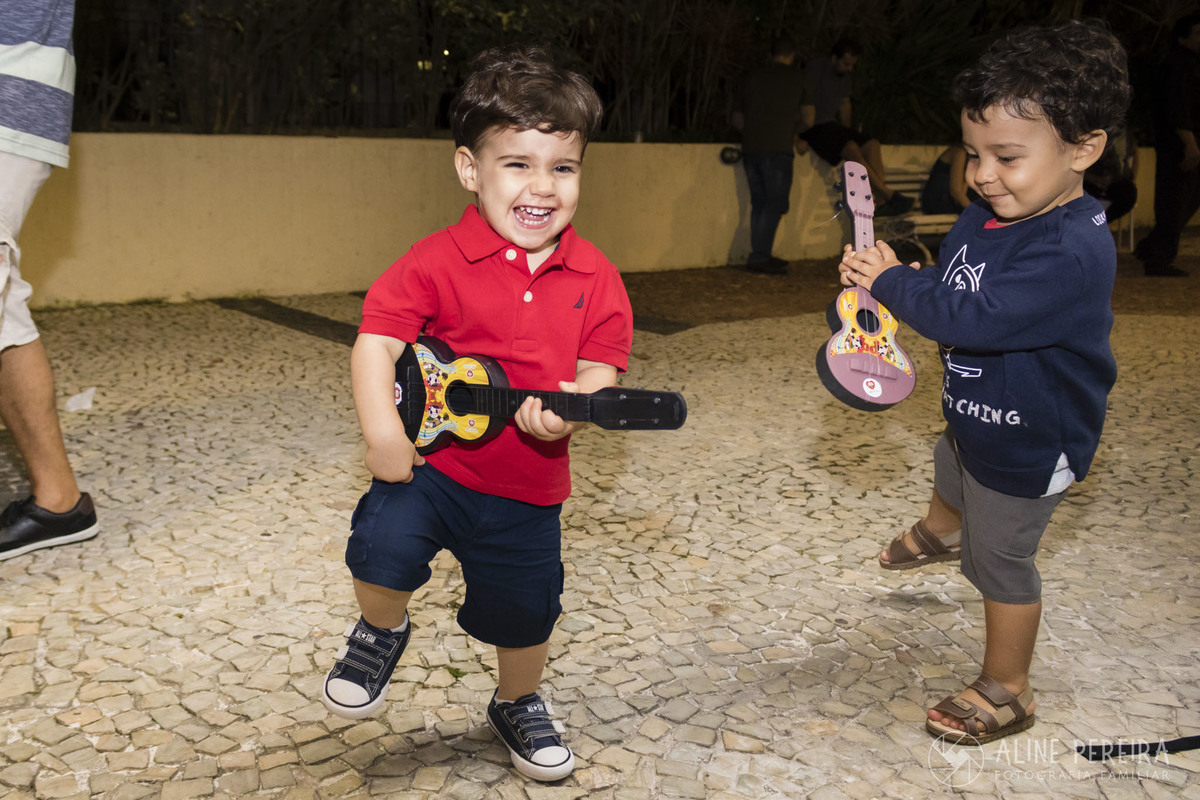 criança tocando violão de brinquedo