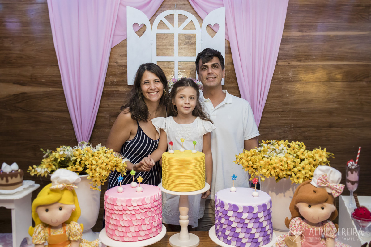 Familia na mesa do bolo com o tema confeitaria na casa de festas Espoleta