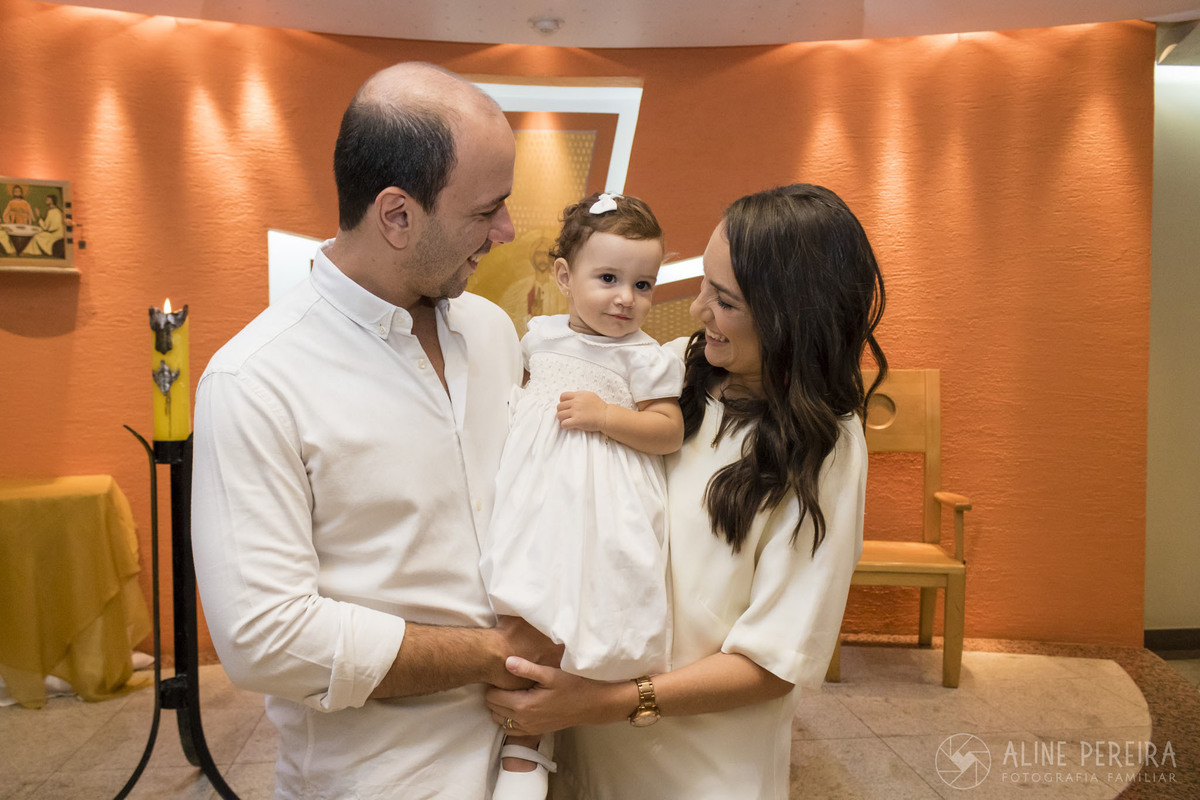 familia em frente ao altar da capela do colegio santo agostinho após o batismo