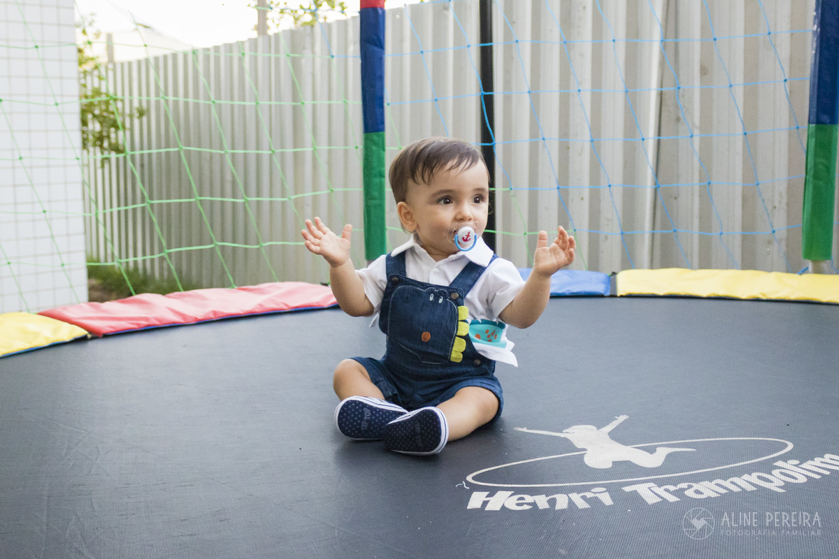 menino de um ano sentado no pula-pula