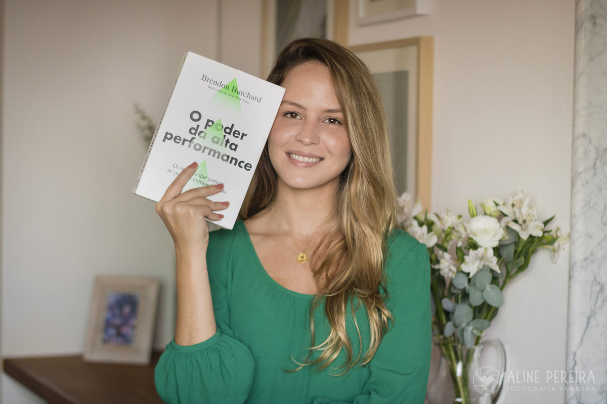 mulher segurando o livro o poder da alta performance