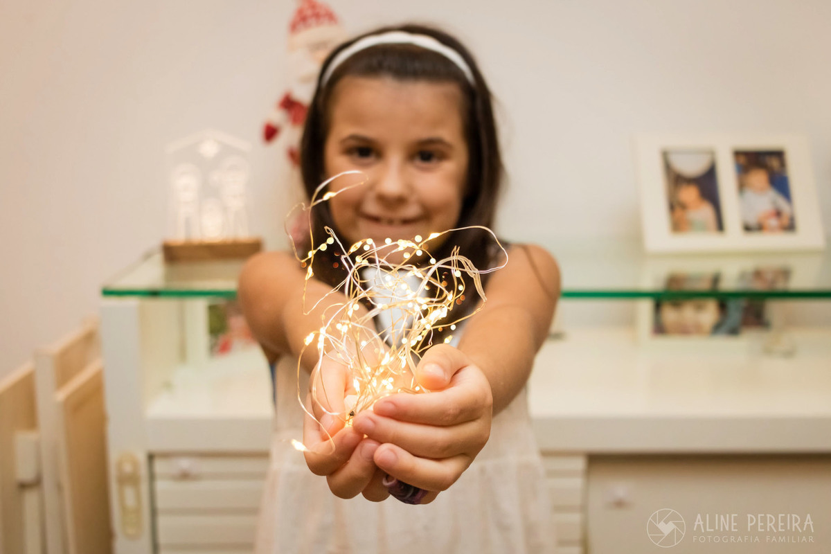 menina segurando fairy lights