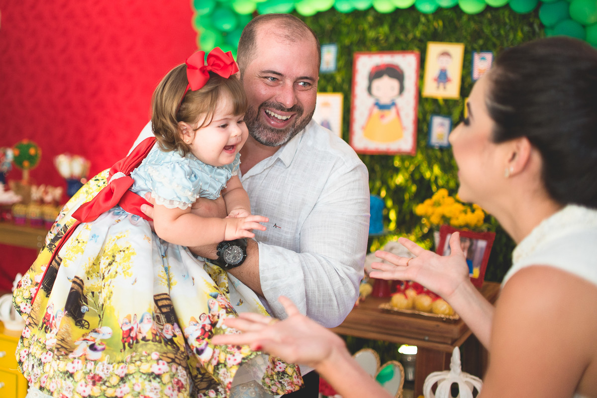 bebê brincando com os pais no seu aniversário