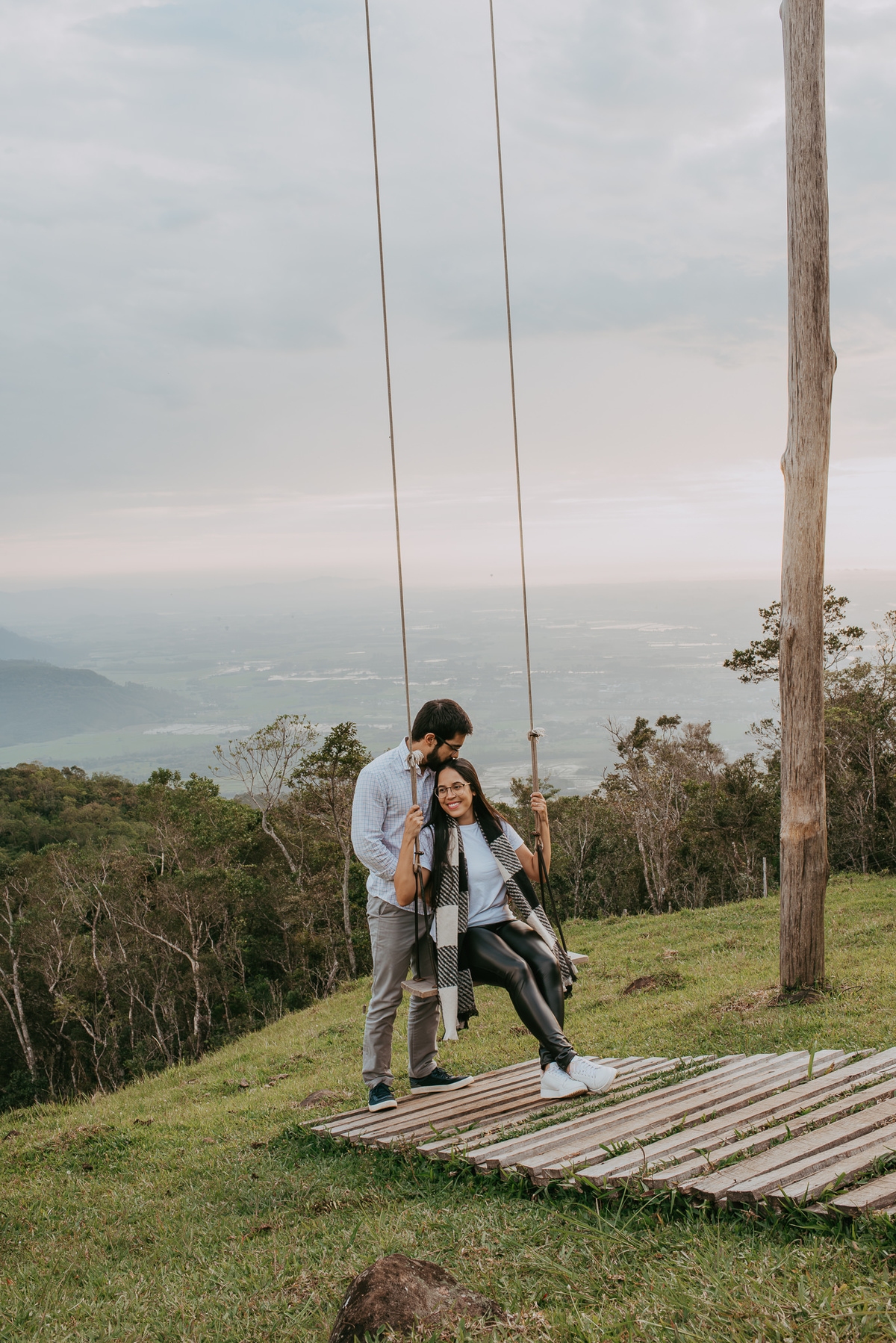 casal andando em um balanço infinito , em ensaio fotográfico casal , em praia grande SC, na encosta dos canyons após piquenique