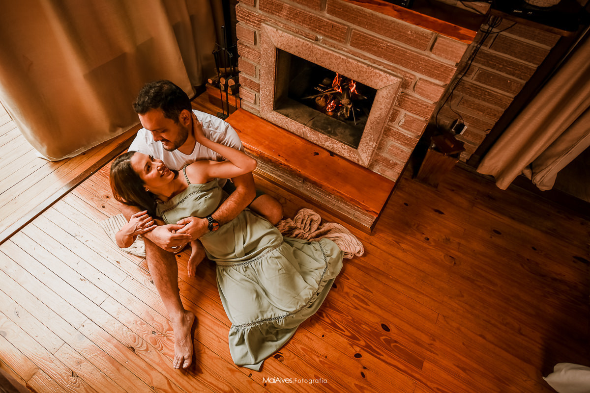 fotografia de casal próximo a lareira 