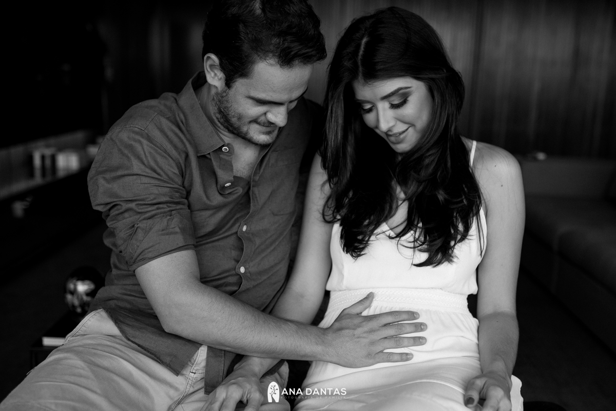 Papai com as maos na barriga com sua bebe 