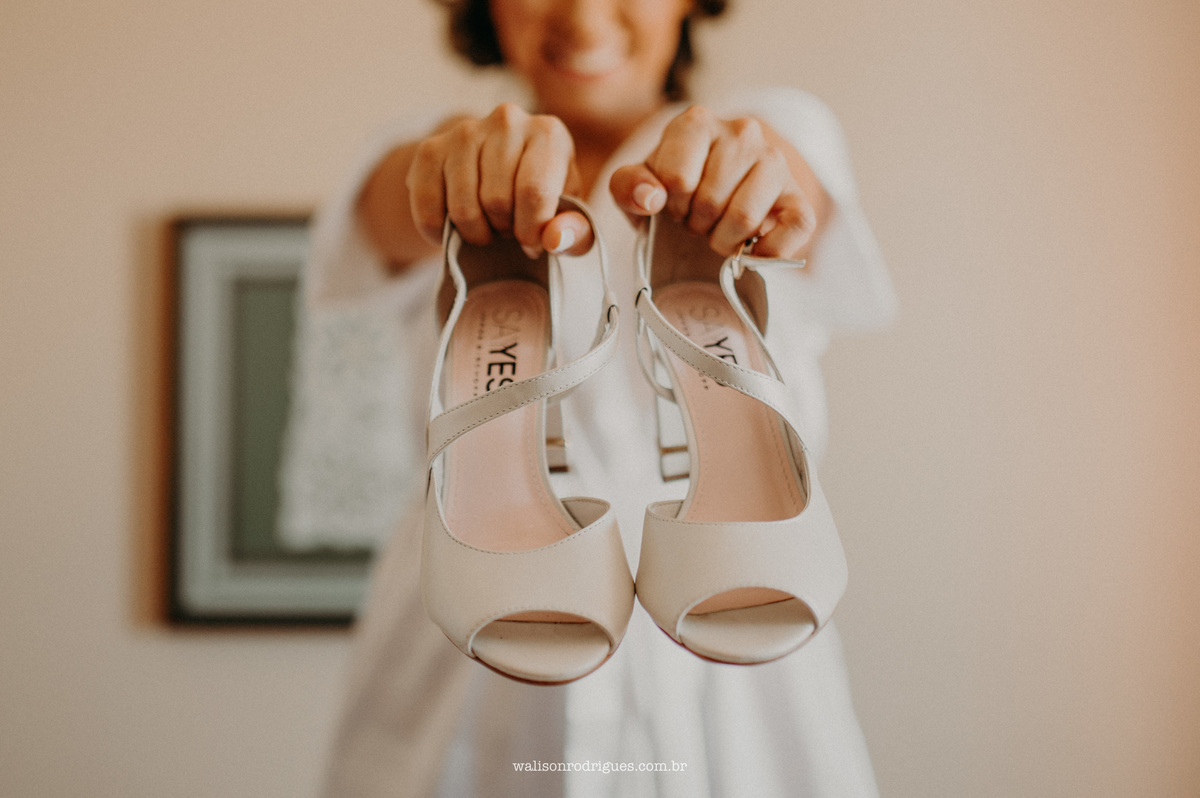 fotografia-da-noiva-no-making-of-segurando-o-sapatos-do-casamento-no-hotel-sonata-de-iracem-em-fortaleza-ce