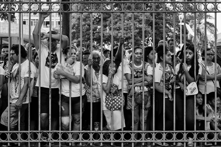 Multidão de fiéis se espremem nas grades para ver a imagem peregrina de Nossa Senhora de Nazaré durante o Círio em Belém do Pará na fotografia de Romero Cruz