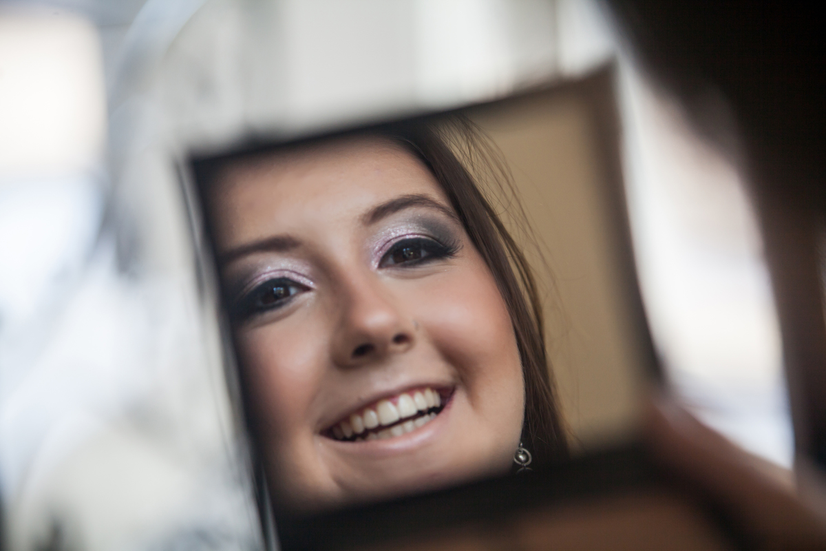 jovem olhando-se no espelho e sorrindo