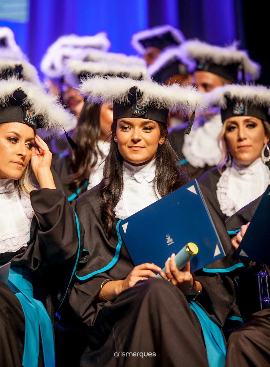 formanda sentindo-se honrada com o diploma em mãos