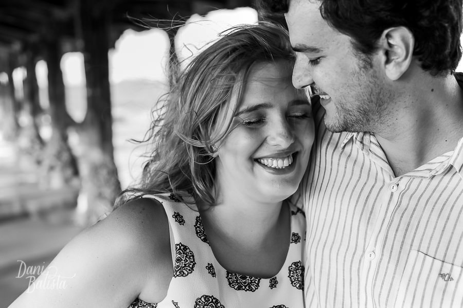 foto do casal sorrindo em ensaio pré-casamento na beira-mar
