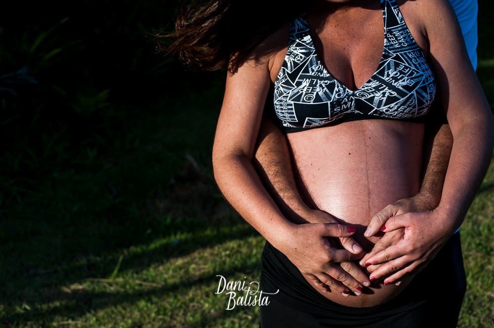 detalhe da barriga durante ensaio fotografico de gestante na praia do grumari rj
