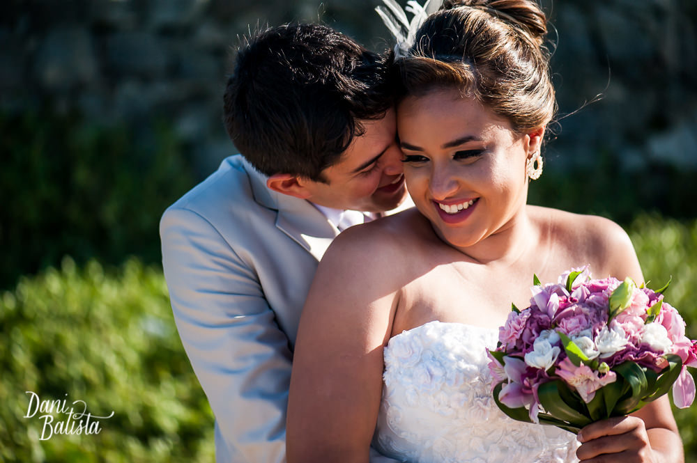noivos beijando a noiva em búzios antes da cerimônia de casamento
