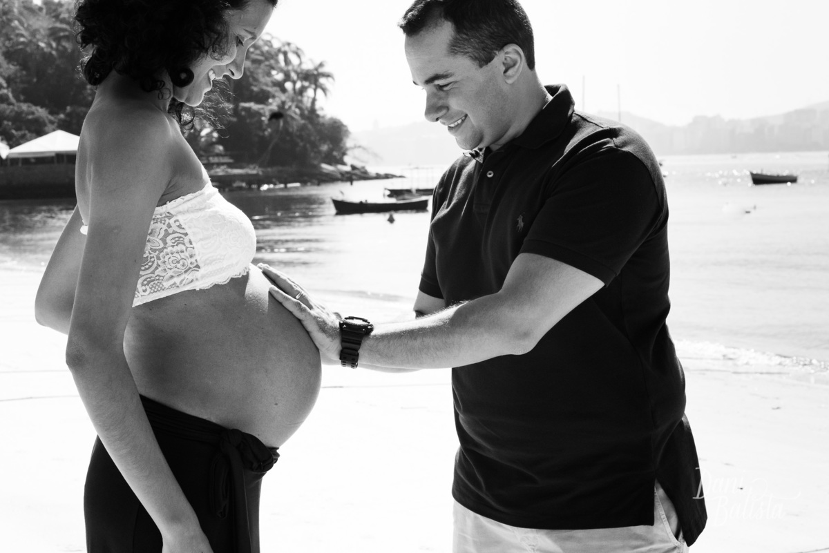 pai colocando a mão na barriga durante ensaio de fotos de gestante em niteroi