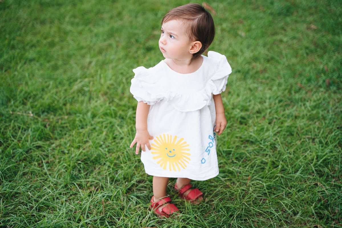 Fotógrafa ES registra ensaio de aniversário de 1 ano ao ar livre em Vila Velha. Fotografia de família lifestyle com piquenique, conexão, carinho e momentos espontâneos. Ensaio infantil no Espírito Santo.